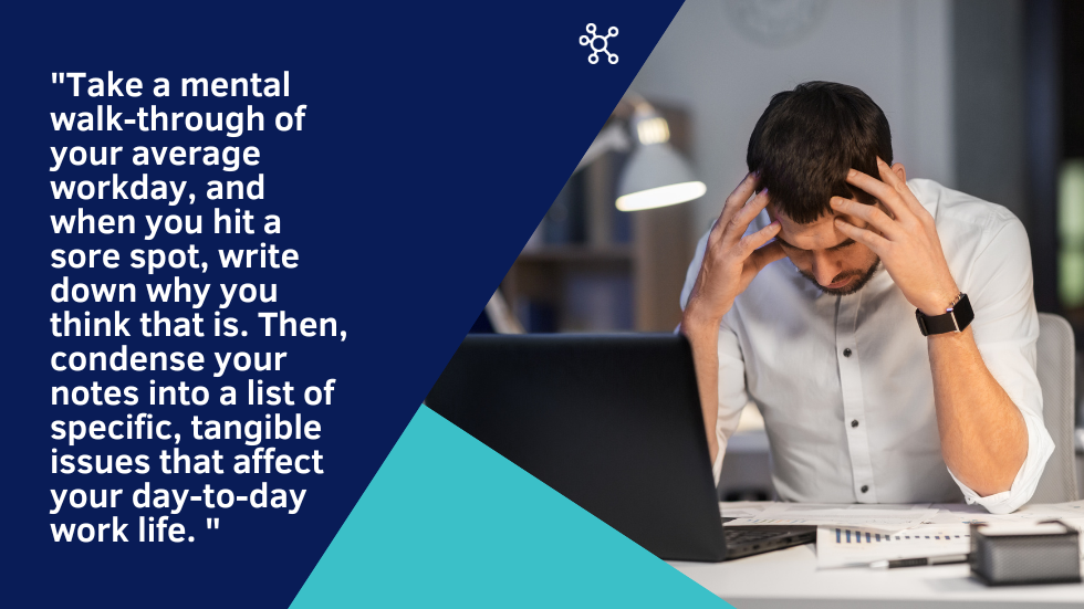 Man with head in hands frustrated at work