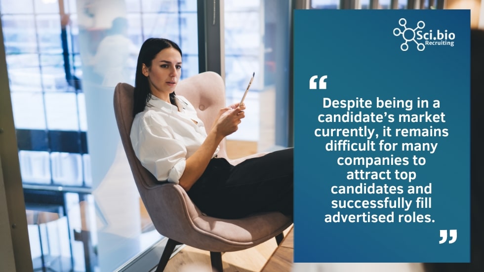 Woman in business clothes sitting in chair holding a pencil to fill a job vacancy