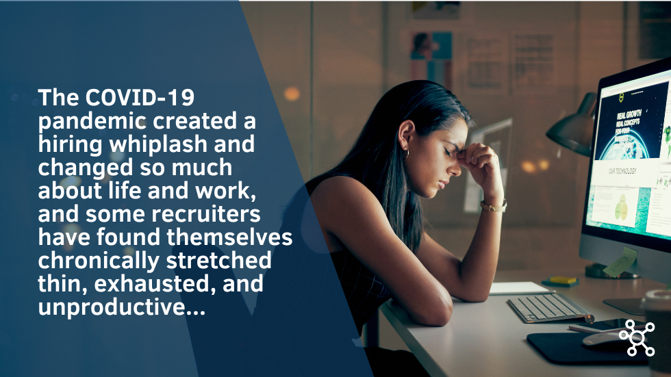 Woman sitting in front of computer screen with head in hand
