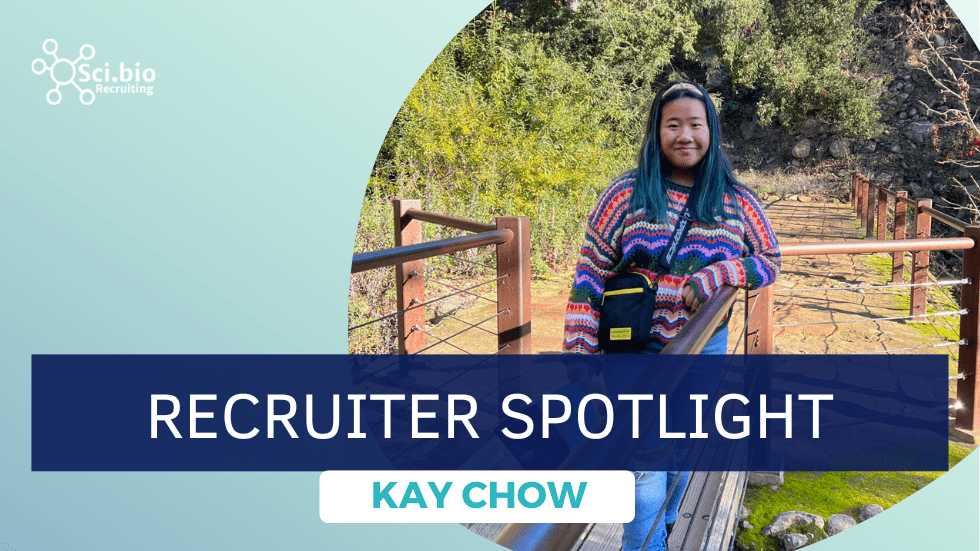 Kay Chow standing by wooden and wire fence