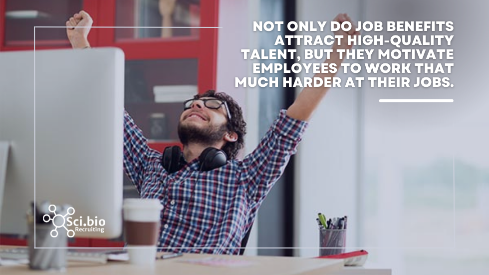man with headphones around neck reaching arms towards air in job perks victory